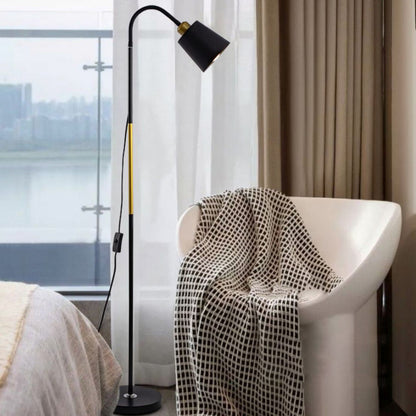 Svart golvlampa vid fåtölj i vardagsrum