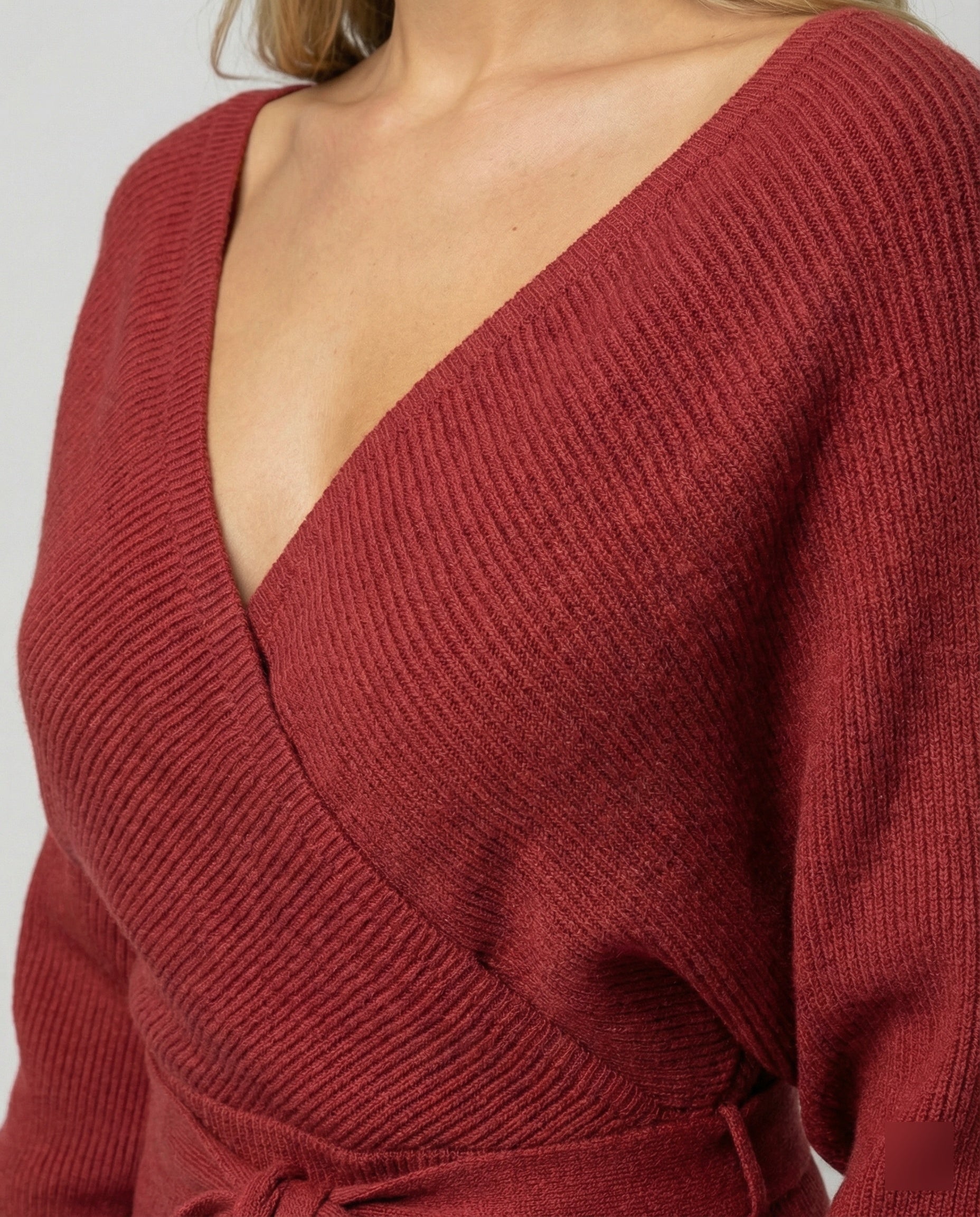 Ladies knit dress with elegant wrap design and decorative belt